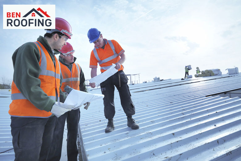 Contractors discussing different commercial roofing materials on a construction site