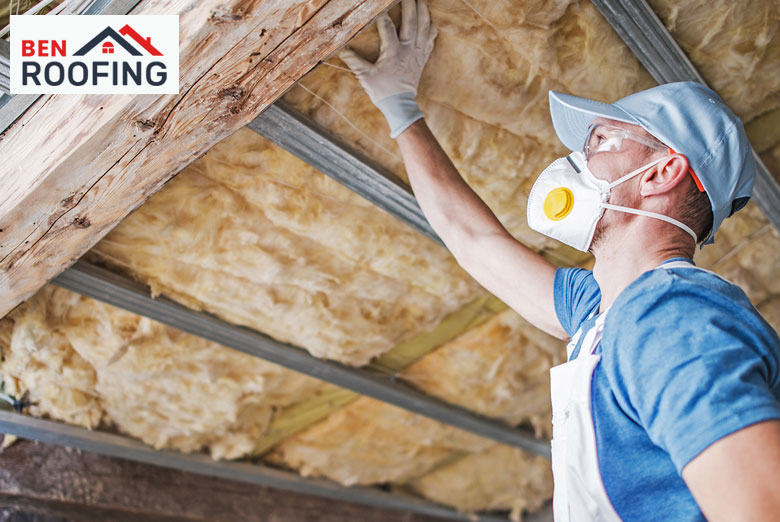 Workers installing new roof insulation to improve energy efficiency